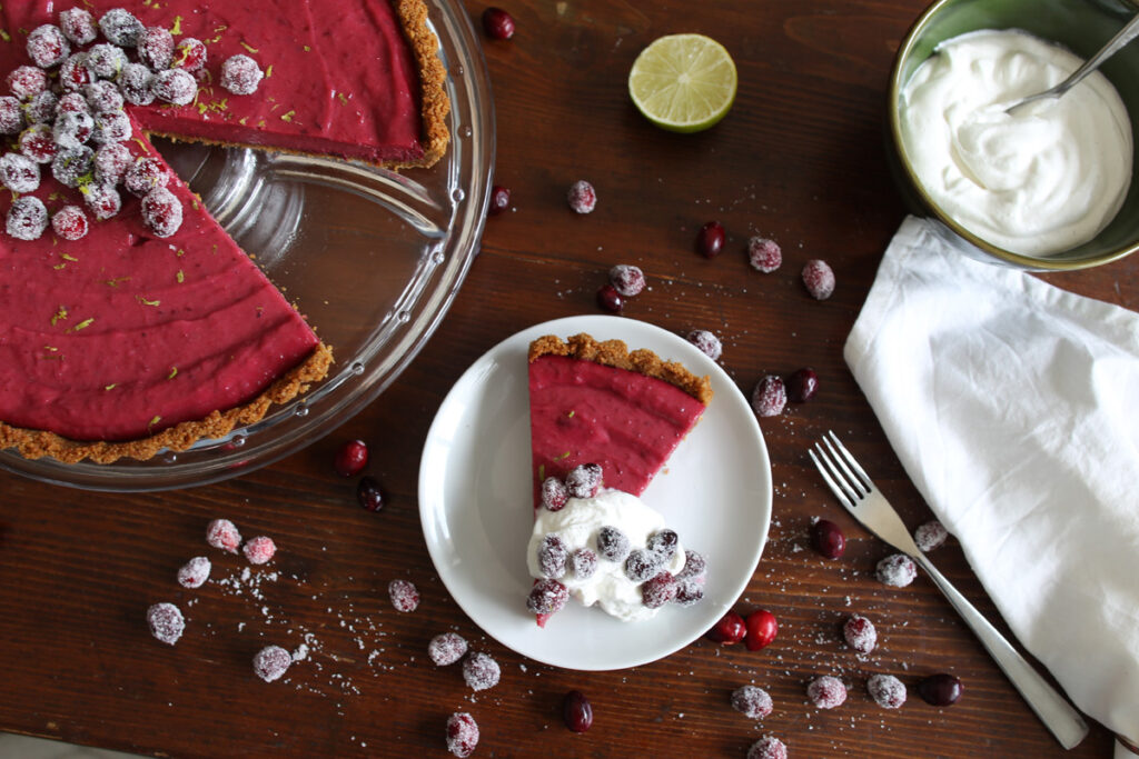 Slice of cranberry and lime pie with whipped cream